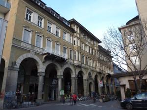 duży budynek przy ulicy miejskiej z rowerami zaparkowanymi na zewnątrz w obiekcie Apartment Leonardo w mieście Bolzano