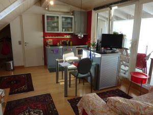 a kitchen and living room with a table and chairs at Apartment Leonardo in Bolzano