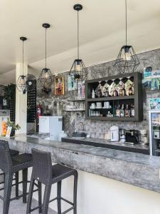a bar with three chairs and a counter with a counter at Sea Hills Resort in Patong Beach