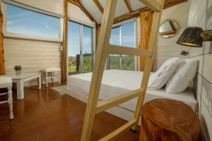 a bedroom with a bunk bed and a large window at Green Leaf in Vanáton