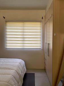 a bedroom with a bed and a large window at Studio Type - Matina Enclaves Residences in Davao City