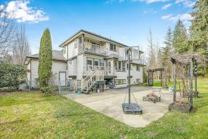 a large house with a playground in the yard at Beautiful 3-bedroom Suite on 1 Acre in Maple Ridge District Municipality