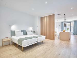 a bedroom with a bed and a desk in a room at Paseo Suites Hotel in Madrid