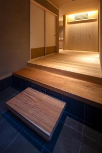 a dance floor with a wooden platform in a room at Tsukihitei in Nara