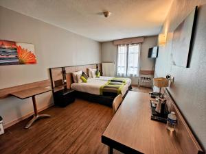 a hotel room with a bed and a desk at Adagio Access Lyon Centre Université in Lyon