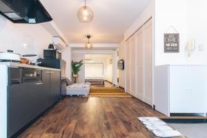 a kitchen with wooden floors and a stove top oven at Nippori Fabric Hotel in Tokyo