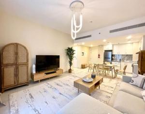 a large living room with a couch and a table at Dar Vacation - Modern Luxury 1BR Apartment in MJL in Dubai