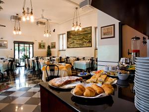 a restaurant with plates of food on a table at Albergo La Marina B&B in Deiva Marina