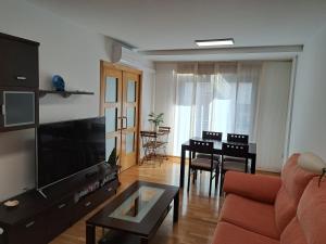 a living room with a couch and a table at APARTAMENTO GUIMAREY in Sanxenxo