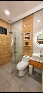 a bathroom with a toilet and a shower and a sink at Obra Maestro Private Resort in Lubao
