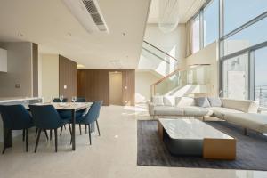 a living room with a couch and a table and chairs at UH FLAT Signature DAEGU in Daegu +118 photos