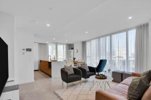 a living room with a couch and chairs at The Gallery Residences Broadbeach in Gold Coast