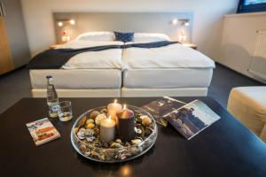 A bed or beds in a room at Felicity Garni Hotel