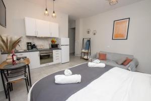 a living room with a large bed and a kitchen at Celestina Corfu Town Apartment in Corfu +54 photos