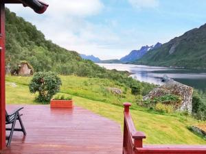 a wooden deck with a view of a lake at 6 person holiday home in Tengelfjord in Tengelfjorden +29 photos