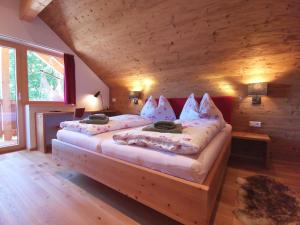 a bedroom with two beds in a log cabin at Luxury chalet in Tauplitz Styria with sauna and swimming pond in Bad Mitterndorf