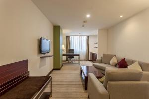 a living room with a couch and a tv at Holiday Inn Shanghai Vista, an IHG Hotel in Shanghai