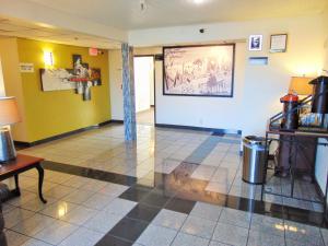 a room with a lobby with yellow walls at Super 8 by Wyndham South Boston VA in South Boston
