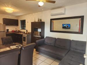 uma sala de estar com um sofá e uma cozinha em VERY SECURED HOUSE 7 MINUTES FROM THE BEACH em Puerto Peñasco