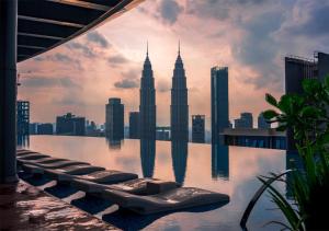 a pool with a view of the petronas towers at EATON Residences by WSD in Kuala Lumpur