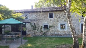 a stone house with a tent in the yard at B&b 500' in Nogaredo Al Torre +7 photos