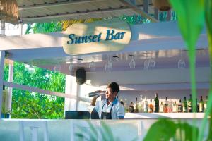 a man standing behind a counter at a cocktail bar at Soul Vacation Resort and Spa,Colva in Colva