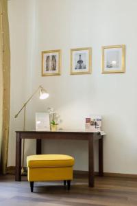 a desk with a yellow stool and a table with a yellow chair at Rhythm and style in Prague city center Andel in Prague