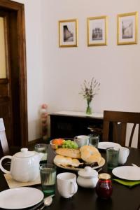 a table with plates and bowls of food on it at Rhythm and style in Prague city center Andel in Prague