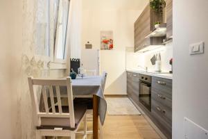 a small kitchen with a table and chairs at Family apartment in Massa Lombarda