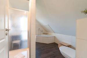 a bathroom with a toilet and a sink at Ferienhaus Karnin B in Karnin (Usedom)