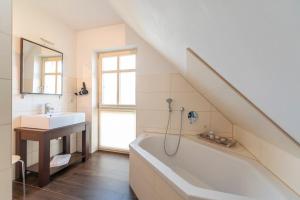 a bathroom with a sink and a bath tub and a sink at Ferienhaus Karnin B in Karnin (Usedom)