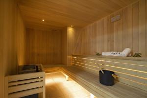 a sauna with wood paneled walls and a wooden floor at Résidence Odalys l'Éclose in L'Alpe-d'Huez