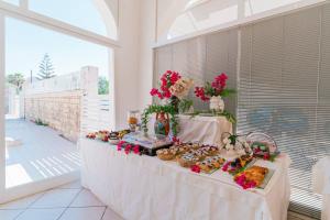 a table with pastries and other foods on it at Hotel Le Dune in Sampieri