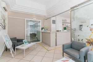 a room with two chairs and a counter in a store at Hotel Le Dune in Sampieri