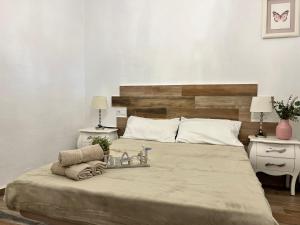 a bedroom with a large bed with two towels on it at Casa en primera linea de playa in Puzol