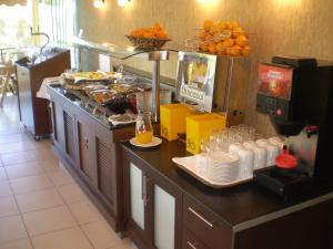 a breakfast buffet in a restaurant with food on a counter at Atrium Hotel Thassos in Potos