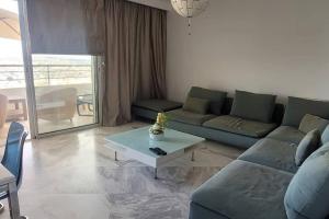 ein Wohnzimmer mit einem Sofa und einem Tisch in der Unterkunft Appartement à Bizerte in Bizerte