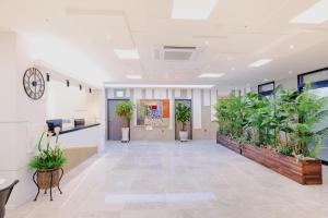 an office hallway with potted plants on the walls at Hotel Arari in Jeonju