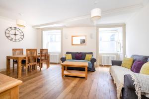 a living room with a couch and a table at ALTIDO Charming 2-bed house with Courtyard in Edinburgh