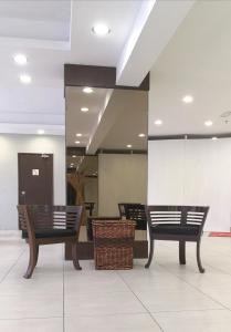 two benches sitting in a lobby with a mirror at Reka Hotel Genting Highlands in Genting Highlands