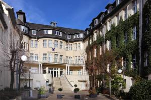 een groot gebouw met een trap ervoor bij Hotel Der Achtermann in Goslar