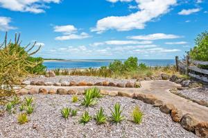 a path to the beach with the ocean in the background at The Inlet Stanley in Stanley