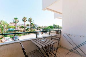 a balcony with a bench and a view of a city at Hotel Le Dune in Sampieri