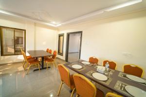 a dining room with a table and chairs at Vrindavan Resort in Mahabaleshwar