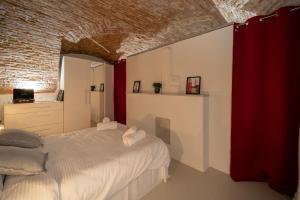 a bedroom with a white bed and a brick wall at 5* luxury in Unirii square. in Cluj-Napoca