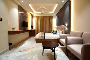 une chambre d'hôtel avec un lit et un canapé dans l'établissement The Sky Imperial Hotel Sugam - 10 Meters from Shrinathji Temple, à Nathdwara
