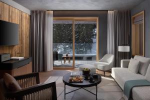 a living room with a couch and a table at Six Senses Crans-Montana in Crans-Montana