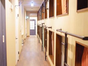 a hallway in a hospital with a row of rooms at 柏島ヴィレッジ in Otsuki