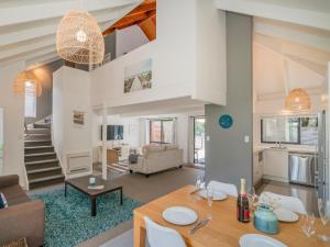 a living room with a dining table and a living room at Beach Road Beauty - Pauanui Holiday Home in Pauanui