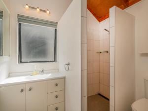 a bathroom with a sink and a shower at Beach Road Beauty - Pauanui Holiday Home in Pauanui +21 photos